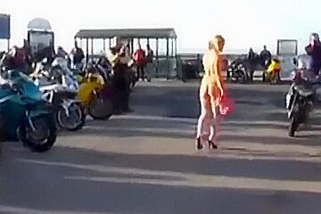 A hot older chick goes walking outside undressed