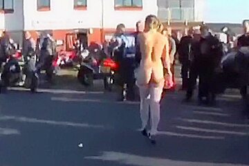 A hot older chick goes walking outside undressed
