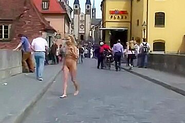 A hot older chick goes walking outside undressed