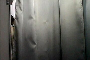 Asian trying on fake big tits on changing room