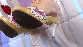 Barefoot babe gives herself a cream foot massage