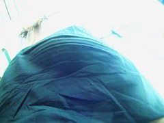 Big ass brunette standing in the city while getting filmed upskirt