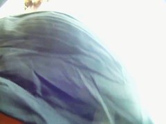 Big ass brunette standing in the city while getting filmed upskirt