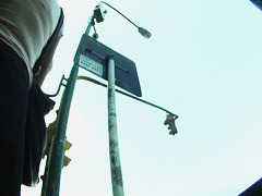 Big ass brunette standing in the city while getting filmed upskirt