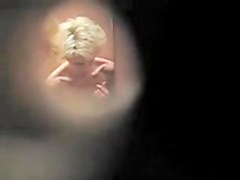 Blonde in changing room with the black bra on tits