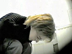 Blonde in glasses getting in the public toilet