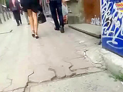 Brunette dish has her black skirt lifted up by the wind
