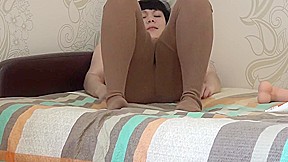Brunette in vintage retro tights masturbates on the bed, big dildo fucks hairy pussy