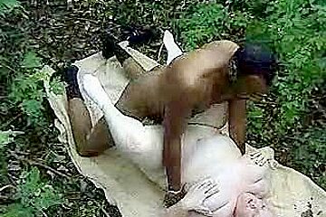 Fat woman taking a big black cock in the woods