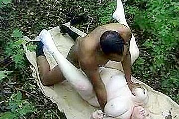 Fat woman taking a big black cock in the woods
