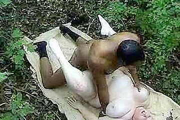 Fat woman taking a big black cock in the woods