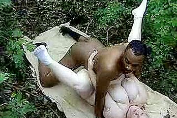 Fat woman taking a big black cock in the woods