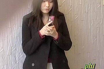 Feisty young Japanese slut holding her phone during sharking adventure