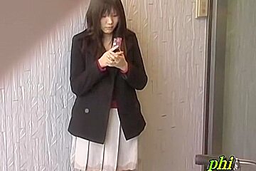 Feisty young Japanese slut holding her phone during sharking adventure