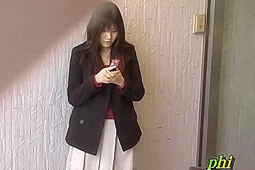 Feisty young Japanese slut holding her phone during sharking adventure