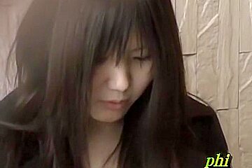 Feisty young Japanese slut holding her phone during sharking adventure