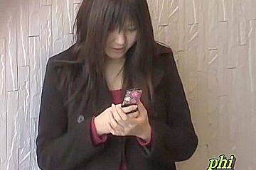 Feisty young Japanese slut holding her phone during sharking adventure