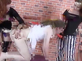 Femdoms spit roast sissy slut with big strapons making him gag and cum