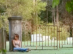 Girl plays in graveyard