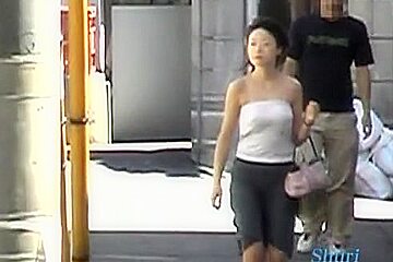In this asian sharking video a guy pulls of the shirt of a sexy woman