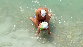 Kama Sutra on the beach Couples have sex in the sea