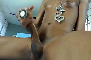 Masturbating black tranny sprays cum