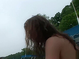 Naughty brunette strips at the beach