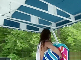 Naughty brunette strips at the beach