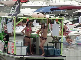 Naughty brunette strips at the beach