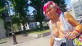 Old woman showing off her big chest