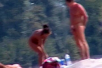 Perky breasted nude beach MILF filmed by a