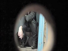 Pretty blonde is smoking and pissing on the toilet