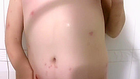 Redhead t-girl in stockings reveals plump ass and shecock