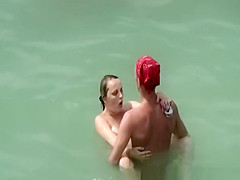 Two nudist couples fucking in the water