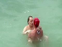 Two nudist couples fucking in the water