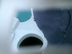 Woman peeing in portable public toilet