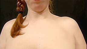 busty redhead gives bondage handjob