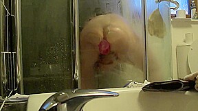 playing with the wifes huge dildo in the shower up my ass