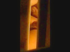 through window - mature couple masturbates each other