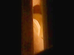 through window - mature couple masturbates each other
