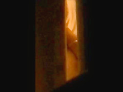 through window - mature couple masturbates each other