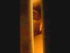 through window - mature couple masturbates each other